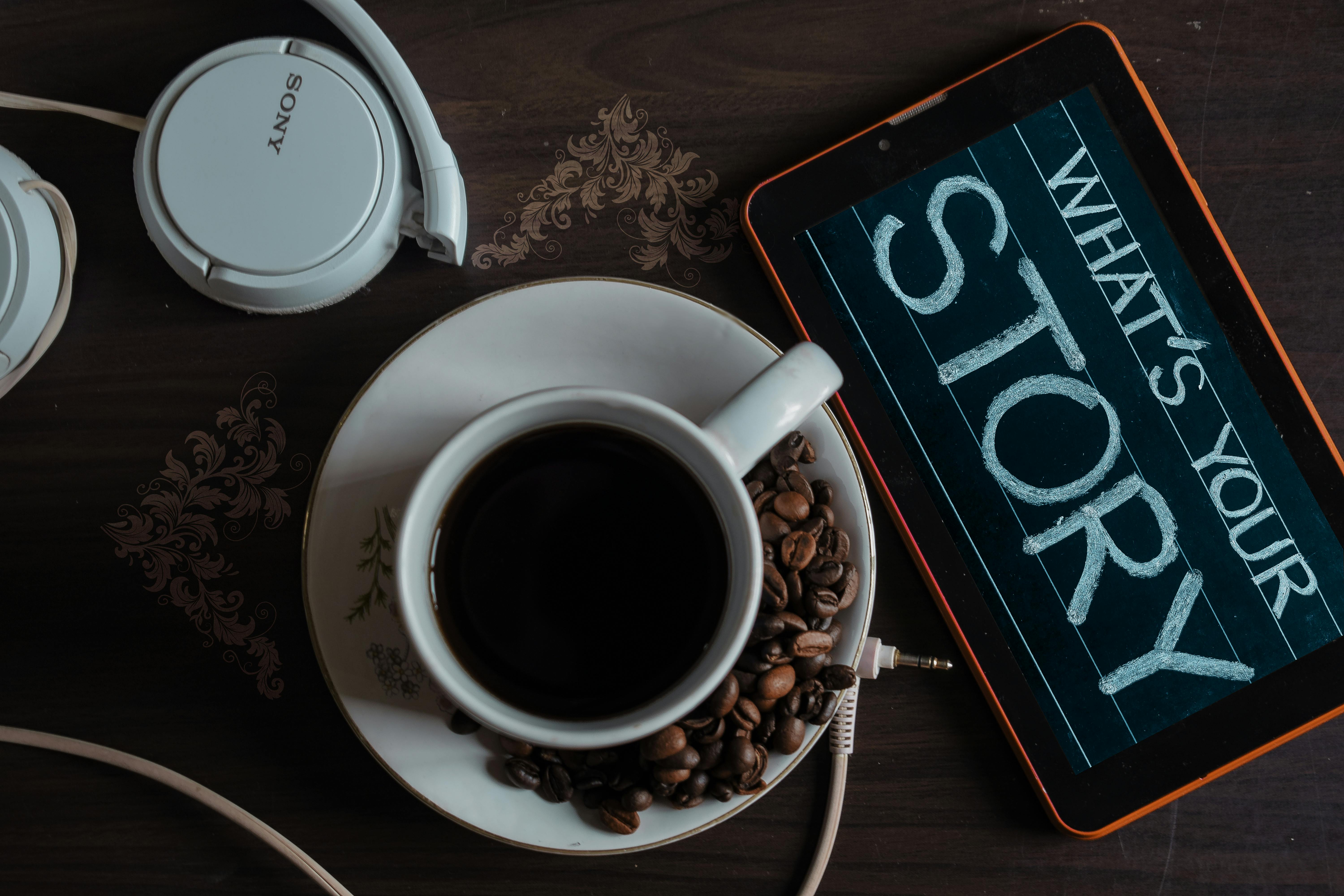 Coffee and tablet that reads 'What's your story?'